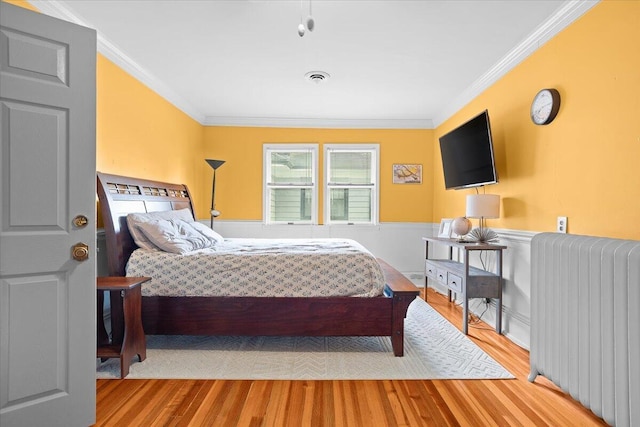 2509 Rosalind Ave SW, Roanoke, VA 24014 - bedroom with radiator, wood finished floors, crown molding, and wainscoting