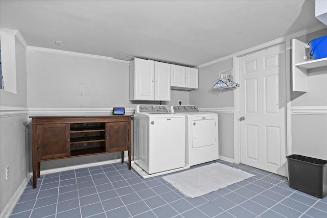 laundry area featuring washing machine and clothes dryer, ornamental molding, tile patterned flooring, and cabinet space