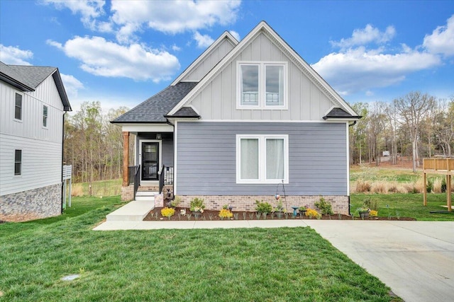 craftsman-style house featuring a front yard and board and batten siding