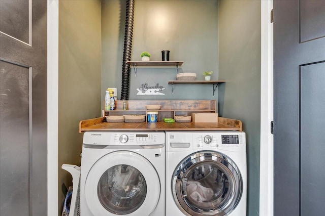 clothes washing area with washer and dryer and laundry area