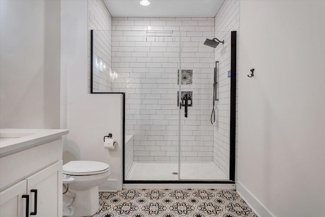 bathroom featuring toilet, tile patterned floors, a shower stall, and vanity