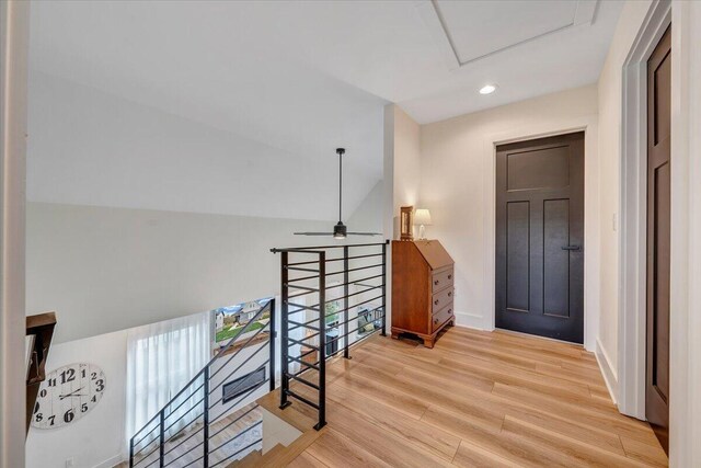 corridor with baseboards, an upstairs landing, recessed lighting, attic access, and wood finished floors