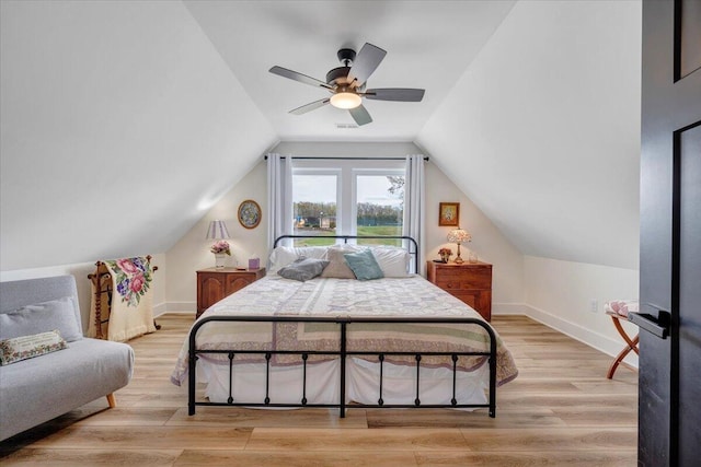 bedroom with light wood-style flooring, baseboards, a ceiling fan, and lofted ceiling