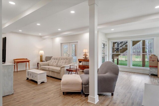 living area featuring french doors, baseboards, light wood finished floors, and recessed lighting