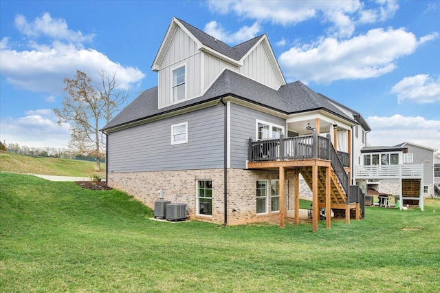 back of property with board and batten siding, stairs, central AC, a yard, and a deck