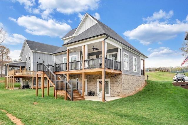 back of property featuring board and batten siding, a yard, stairway, a patio area, and a shingled roof