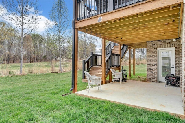 view of yard with a patio area and stairway