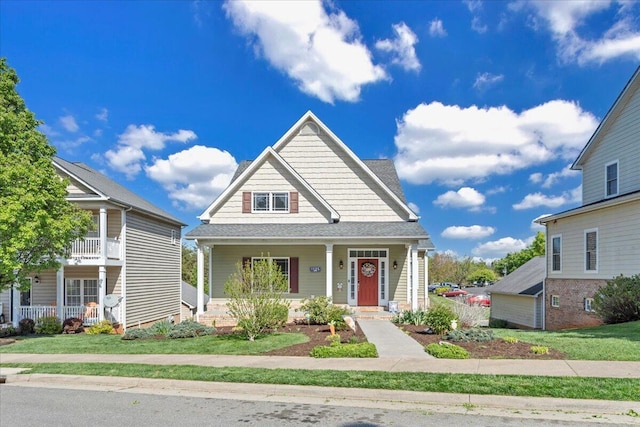 view of front of house featuring a shingled roof and covered porch