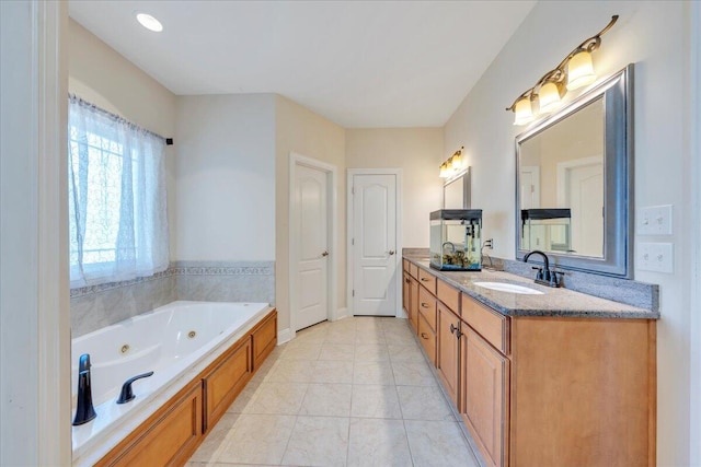 bathroom with a whirlpool tub, tile patterned floors, and vanity