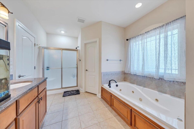 bathroom featuring a stall shower, visible vents, a whirlpool tub, tile patterned flooring, and vanity
