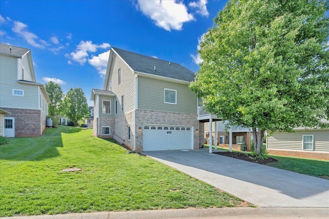 view of front of home with driveway, brick siding, a front yard, and a garage