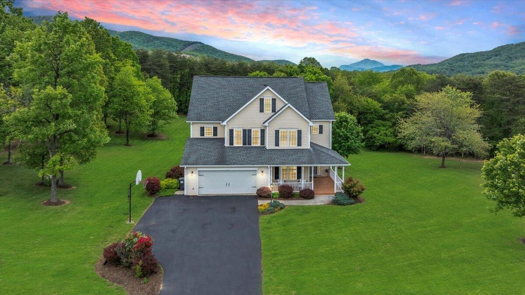 466 Thornblade Way, Blue Ridge, VA 24064 - traditional-style home featuring a porch, asphalt driveway, a lawn, a mountain view, and an attached garage