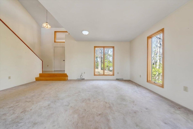 unfurnished living room with visible vents and carpet