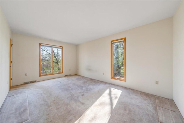 carpeted spare room with visible vents