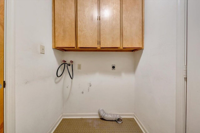 washroom featuring baseboards, hookup for an electric dryer, washer hookup, and cabinet space