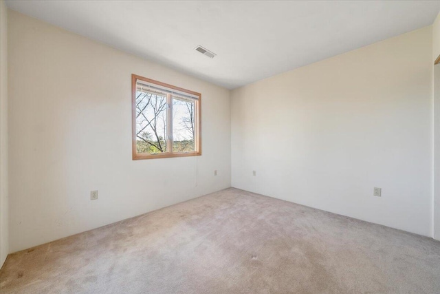 empty room with carpet and visible vents