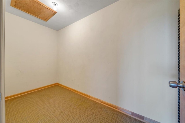 carpeted empty room with baseboards