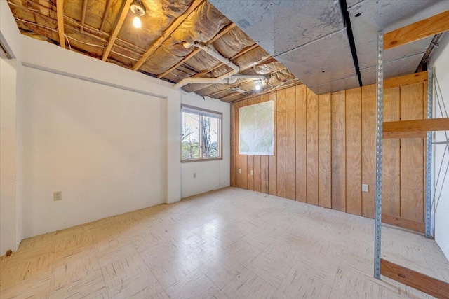 below grade area featuring wood walls
