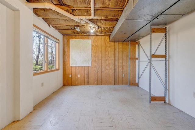 below grade area featuring wood walls