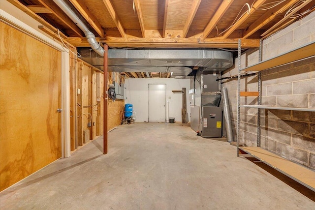 unfinished basement featuring heating unit
