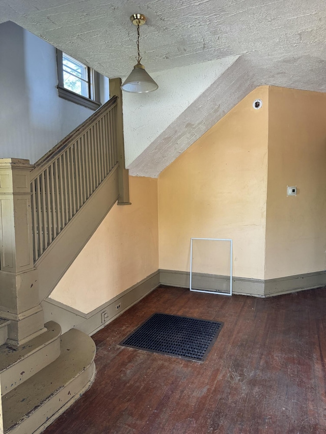 interior space featuring wood-type flooring and baseboards
