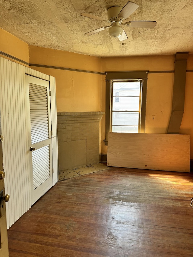 empty room with ceiling fan and hardwood / wood-style flooring