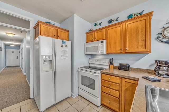 1245 Graves Harbor Trl Unit 206, Huddleston, VA 24104 - kitchen featuring white appliances, brown cabinets, light tile patterned flooring, and a sink