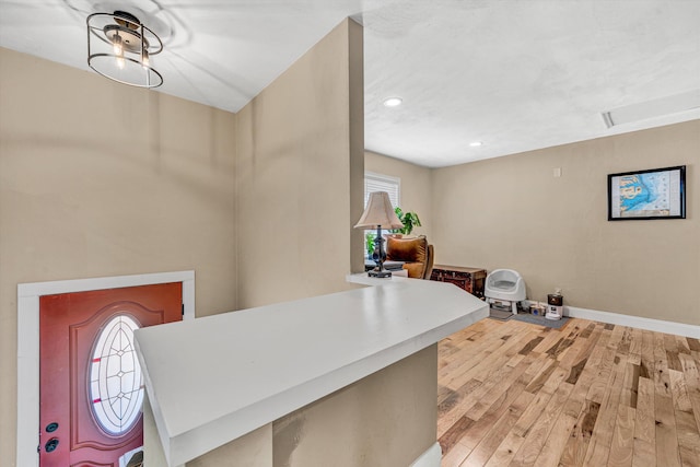entryway featuring light wood-type flooring, baseboards, and recessed lighting