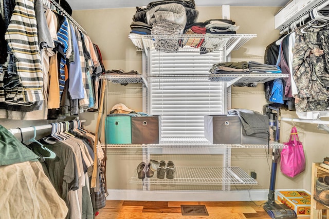 walk in closet featuring wood finished floors and visible vents