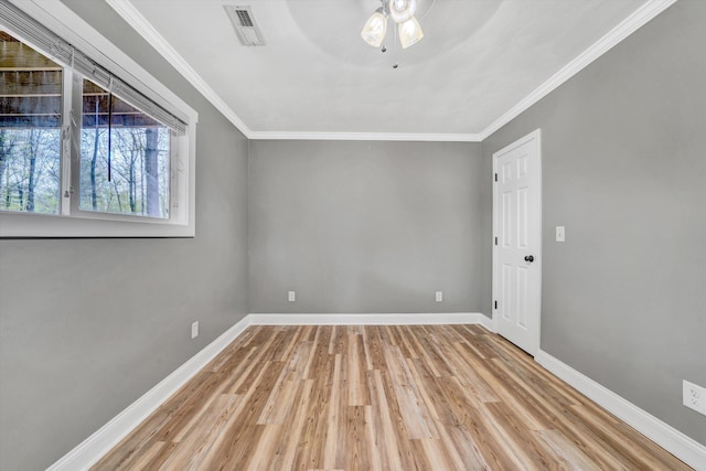 unfurnished room featuring visible vents, baseboards, ornamental molding, a ceiling fan, and wood finished floors