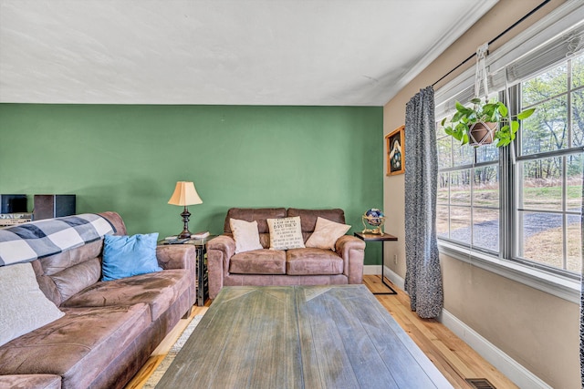 living area with baseboards and hardwood / wood-style floors