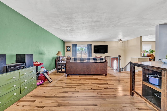 living room featuring baseboards and hardwood / wood-style flooring
