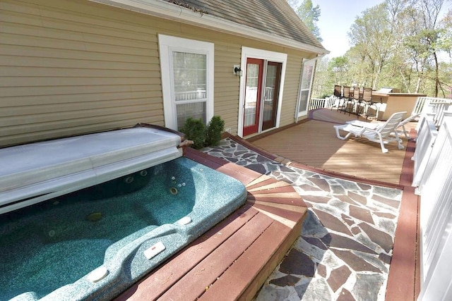 wooden deck featuring hot tub deck surround