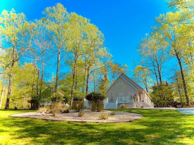 view of property exterior with a porch and a lawn