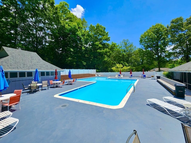 community pool featuring a patio and a fenced backyard