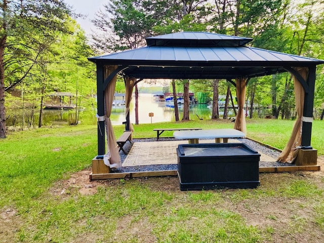 exterior space featuring a gazebo and a water view
