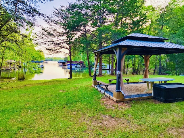 view of home's community with a water view, a gazebo, and a lawn