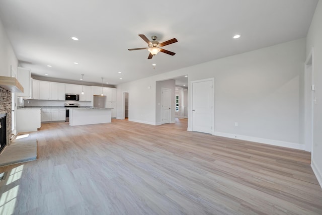 45 Island Green Rd, Daleville, VA 24083 - unfurnished living room with a ceiling fan, light wood-style floors, a fireplace, and recessed lighting