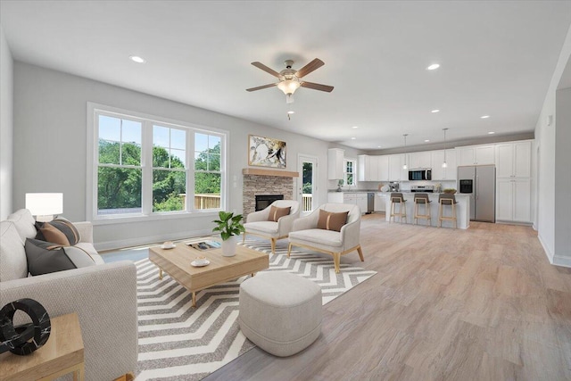 45 Island Green Rd, Daleville, VA 24083 - living area with a ceiling fan, light wood-style flooring, a stone fireplace, and recessed lighting