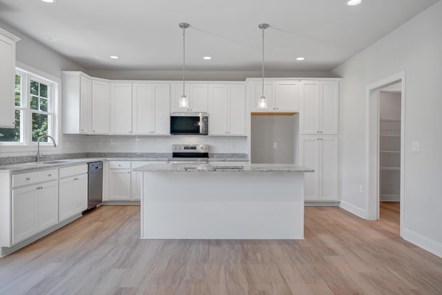 45 Island Green Rd, Daleville, VA 24083 - kitchen with stainless steel appliances, tasteful backsplash, light wood finished floors, white cabinetry, and recessed lighting
