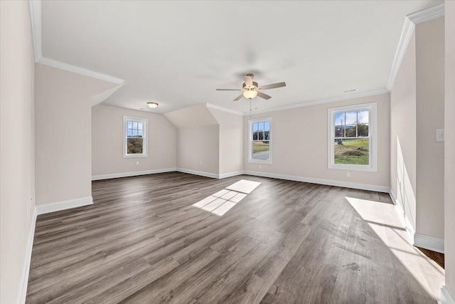 bonus room featuring a healthy amount of sunlight, baseboards, ceiling fan, and wood finished floors