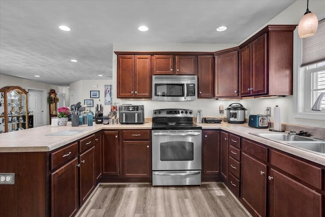 38 Point Pleasant Ave, Salem, VA 24153 - kitchen with light wood finished floors, a peninsula, appliances with stainless steel finishes, and light countertops
