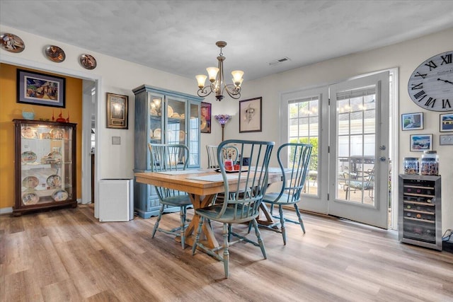 38 Point Pleasant Ave, Salem, VA 24153 - dining area with wine cooler, light wood finished floors, visible vents, and a chandelier