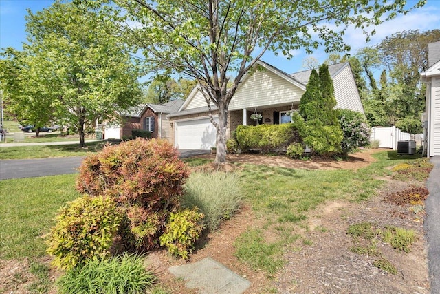 38 Point Pleasant Ave, Salem, VA 24153 - view of front of house with fence, a garage, central AC unit, driveway, and a front lawn