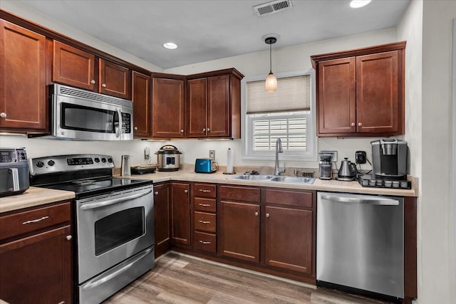 38 Point Pleasant Ave, Salem, VA 24153 - kitchen with a sink, visible vents, stainless steel appliances, light countertops, and light wood finished floors