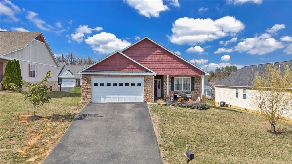 28 Primrose Ct, Roanoke, VA 24019 - craftsman inspired home with driveway, stone siding, an attached garage, and a front lawn