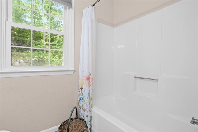full bathroom with shower / bath combination with curtain and baseboards