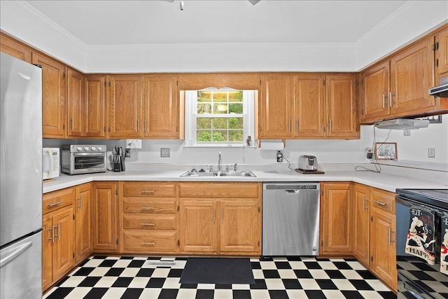 kitchen featuring stainless steel appliances, a sink, light floors, light countertops, and crown molding