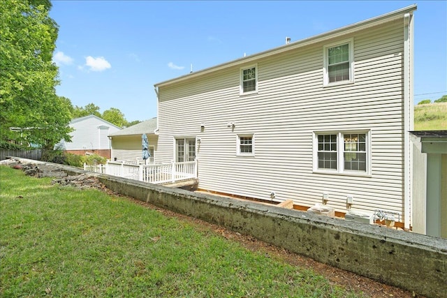 rear view of property with a lawn