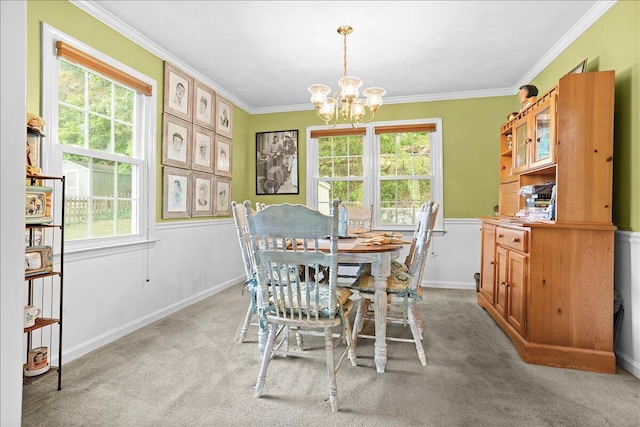 dining room featuring a chandelier, light carpet, healthy amount of natural light, and ornamental molding